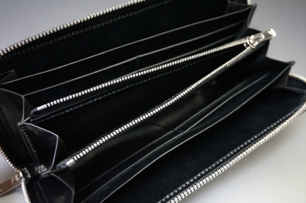 Black zip-around wallet opened to reveal multiple card slots and a central zip compartment, empty and ready for use.