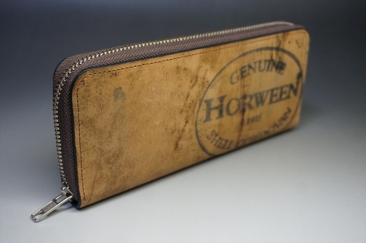 Brown leather zippered wallet with a faded Horween Genuine stamp on the front.