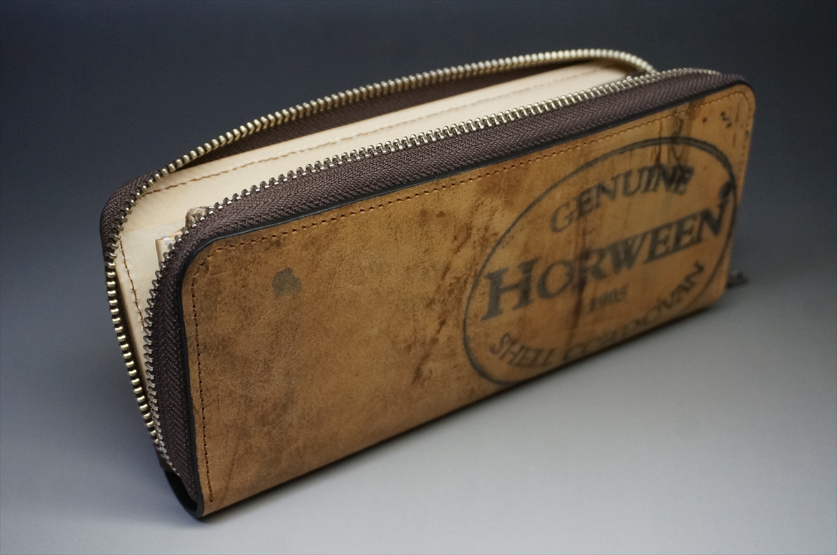 Brown leather zippered wallet with two zippers and a Horween stamp on the front.