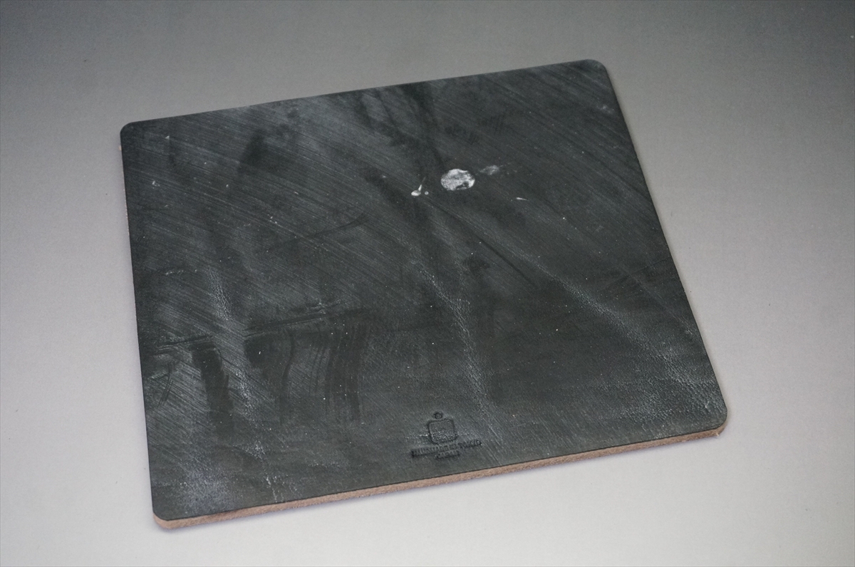 Rectangular black slate serving board with rounded corners on a light surface